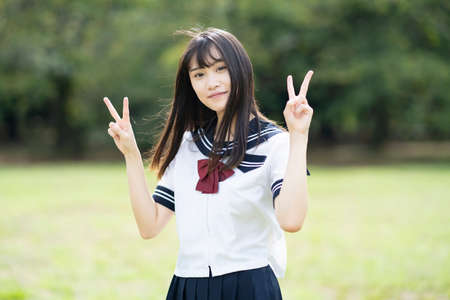 High school student posing with a V sign with a smileの写真素材
