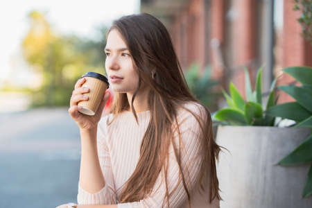 Young woman relaxing with a coffee cup in her handの写真素材