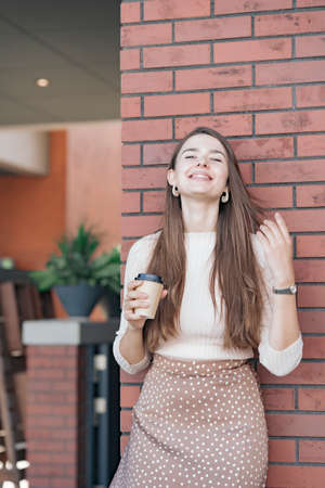Young woman relaxing with a coffee cup in her handの写真素材