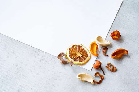 White paper and dried plants placed on a concrete plane