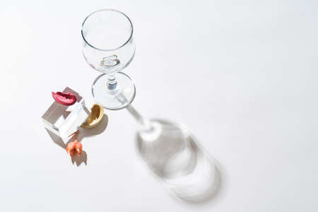 The shadow of the wine glass is falling on a white background