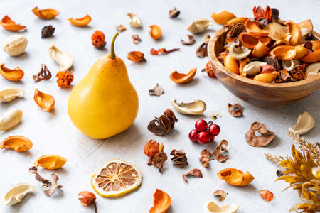 Still life of a pear, dried fruits and dried plants