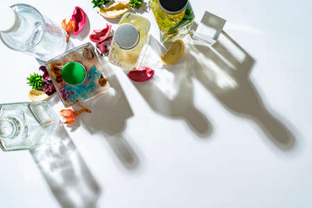 Colorful herbarium bottles and shadows on white boardの写真素材