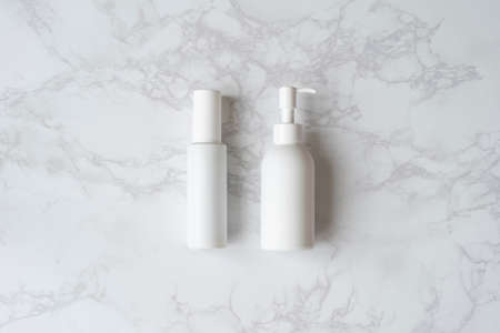 An empty white bottle placed on a marble tableの写真素材