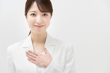 A woman in a white suit in a relief poseの写真素材