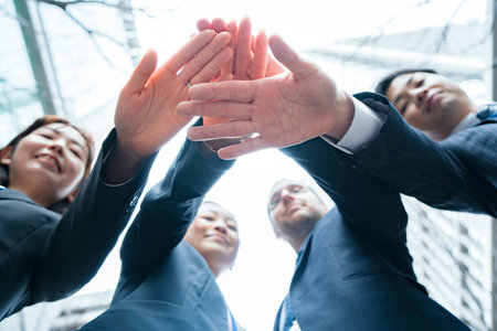 A business team holding hands on the streets of the business districtの写真素材