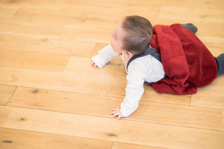 Japanese baby crawling on the wooden floor in the roomの写真素材