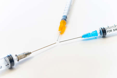 Syringe placed on white paper