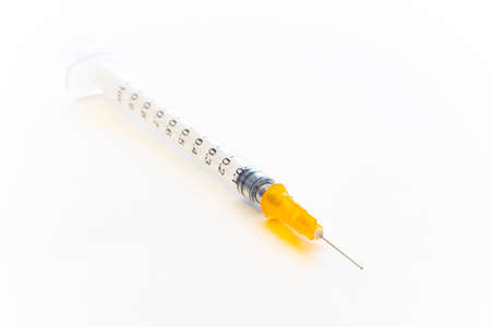 Syringe placed on white paper