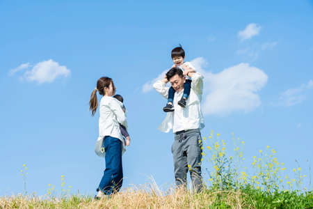 Asian parents and children taking a walk with a smileの写真素材