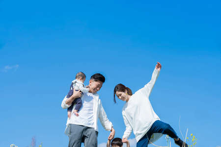 A family taking a walk while having fun on fine dayの写真素材