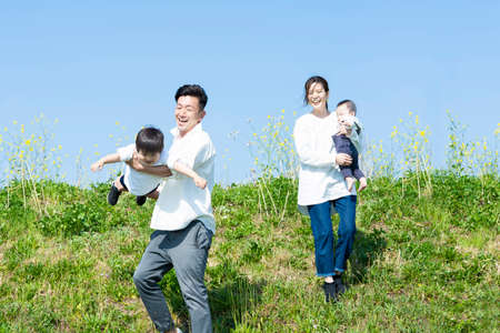 A family taking a walk while having fun on fine dayの写真素材