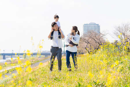 Asian parents and children taking a walk with a smileの写真素材