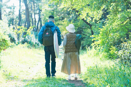 Man and woman heading to the campsite with their luggage