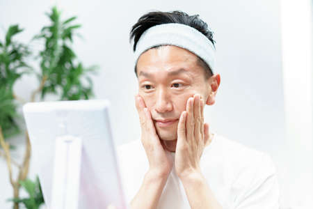 Asian middle men doing skin care in the room