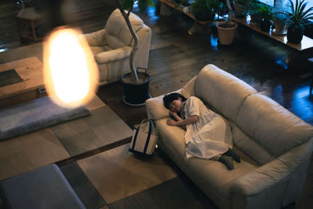 Young woman resting on the sofa in the evening