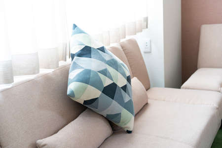 Bright interior with sofa and cushions, hotel room