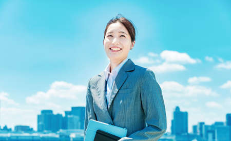 City center, blue sky and asian young business woman