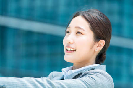 Portrait of young asian business woman in an office district