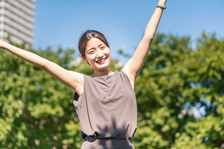 Asian young woman relaxing in the greenの写真素材