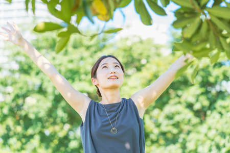 Asian young woman relaxing in the greenの写真素材