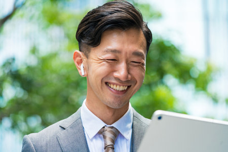 Asian businessman who communicates online using a tablet PCの写真素材