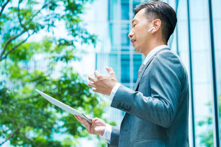 Asian businessman who communicates online using a tablet PC
