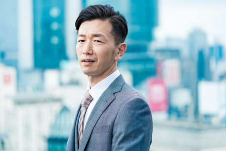 Asian businessman with a stressed lookの写真素材