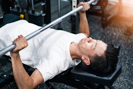 Middle-aged asian man training in the gym