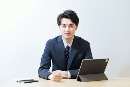 Portrait of asian young businessman indoorsの写真素材