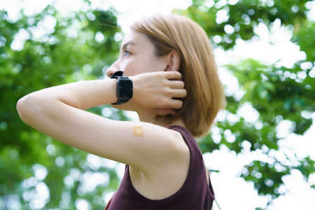 Middle-aged woman's arm patched after vaccinationの写真素材