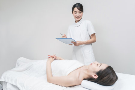 Asian female staff at an esthetic salon providing counselingの写真素材