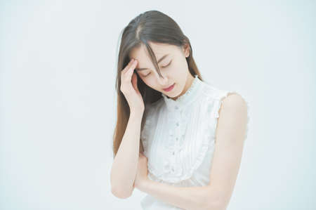 Asian young woman with a stressed lookの写真素材
