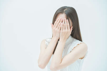 Asian young woman with a stressed lookの写真素材