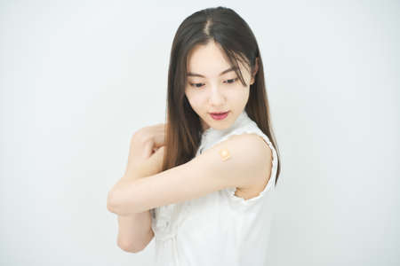 Young female arm with vaccination patchの写真素材