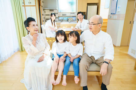 2 little granddaughters talking to grandparents in the roomの写真素材