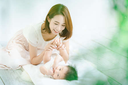 Asian mom and baby playing indoorsの写真素材