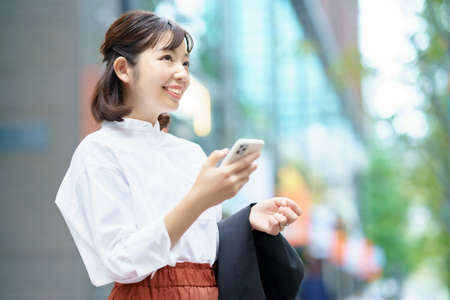 asian woman holding a smart phoneの写真素材