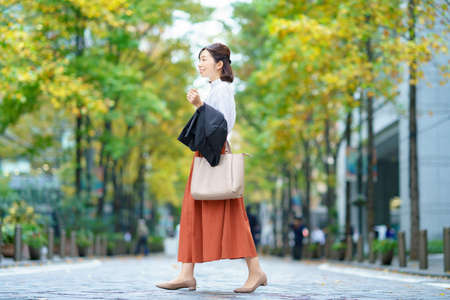 Female commuting in office casual style in business districtの写真素材