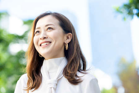Outdoor portrait of smiling woman on fine dayの写真素材