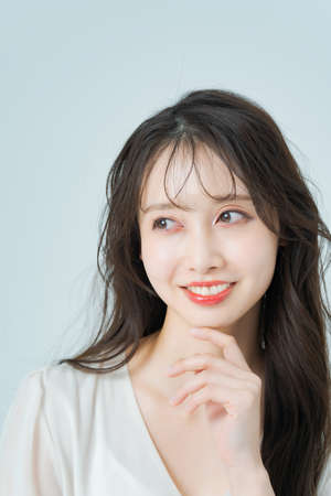 Young woman with long hair with make-upの写真素材