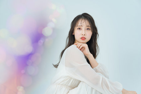 Long-haired woman with make-up and colorful front bokehの写真素材