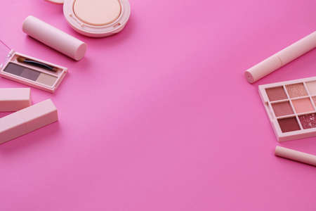 A set of makeup tools and a pink backgroundの写真素材