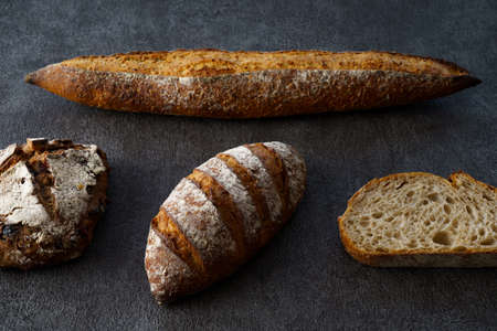 Different types of bread on the dark tableの写真素材