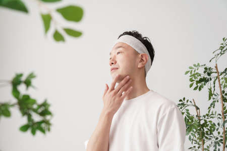 Asian middle man checking skin conditionの写真素材