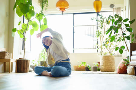 Asian woman stretching in the room