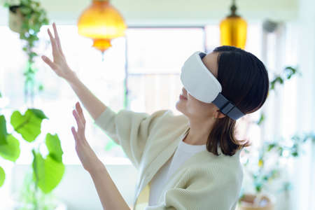 A woman wearing VR goggles in the room and groping