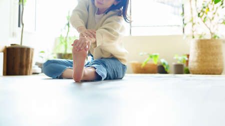 Asian woman stretching in the roomの写真素材