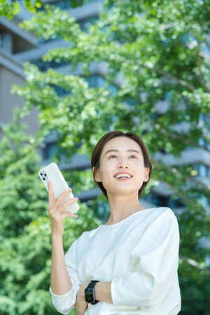Young woman holding a smartphone outdoors
