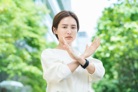 Young business woman signing NG outdoorsの写真素材